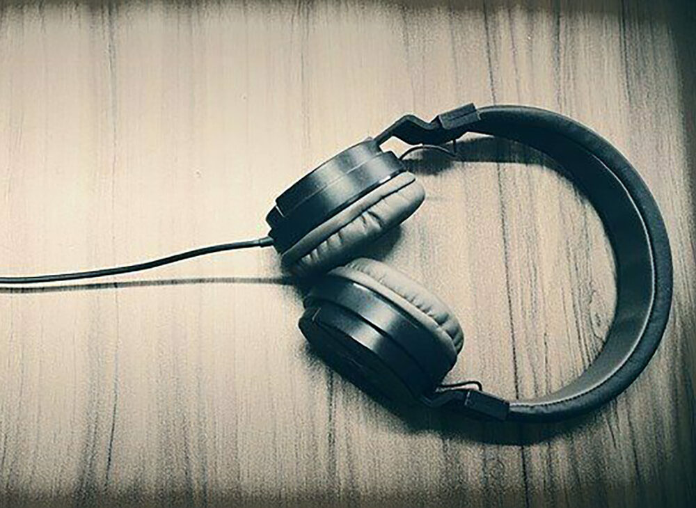 A pair of headphones laying on a table.
