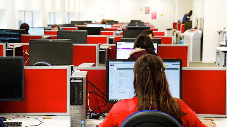 Image of students sat at computer workstations