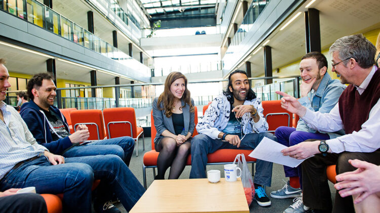 A group of students and professor having a conversation.