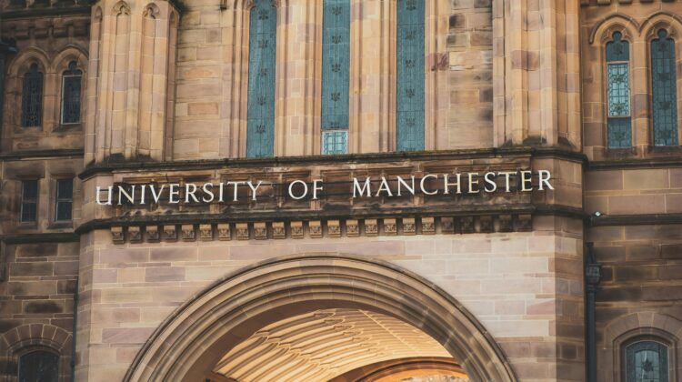 Picture of 'University of Manchester' sign on the iconic Whitworth Hall university building on Oxford Road