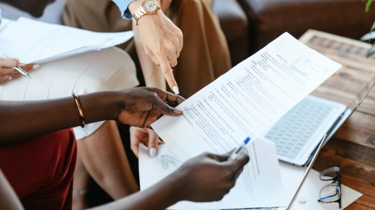 Two people looking at an application form