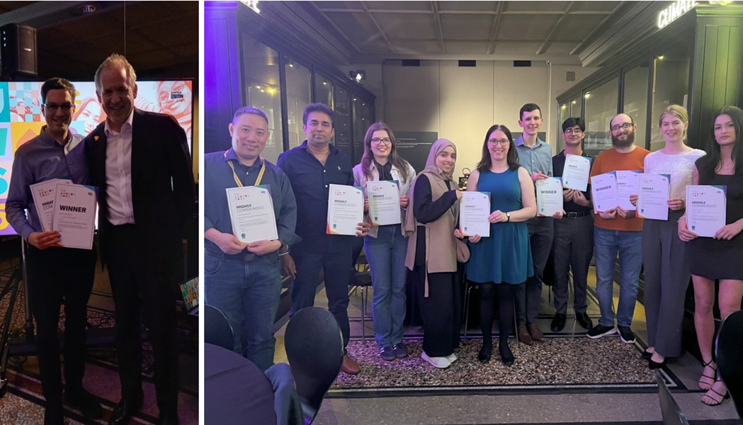 Image of people holding certificates at an awards ceremony