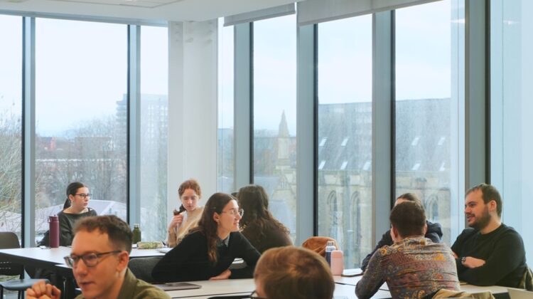 graduate teaching assistants sat around tables in a meeting room