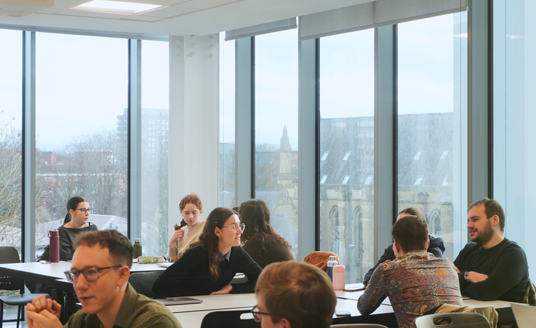 graduate teaching assistants sat around tables in a meeting room